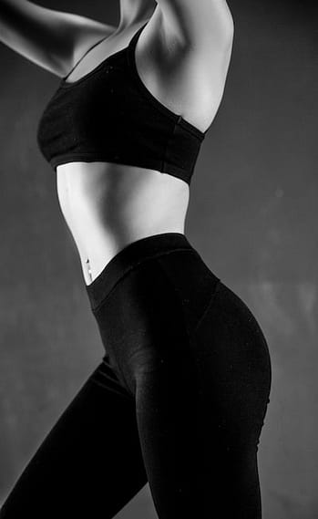 image noir et blanc d'un corps de femme mince en tenue de sport  